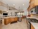 Spacious kitchen with stainless steel appliances, a central island, and a view of the dining area at 190 Montelluna Dr # North, North Venice, FL 34275