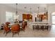 Bright kitchen with dark wood cabinetry and island, pendant lights and a dining area at 190 Montelluna Dr # North, North Venice, FL 34275