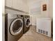 Laundry room with washer, dryer, and built-in cabinets for storage at 190 Montelluna Dr # North, North Venice, FL 34275