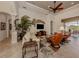 Inviting living room with a tray ceiling, ceiling fan, and plush seating at 190 Montelluna Dr # North, North Venice, FL 34275