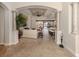 Bright living room featuring tile floors, modern decor, columns, and an open floor plan with natural light at 190 Montelluna Dr # North, North Venice, FL 34275