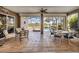 Bright and open covered patio with comfortable seating, dining and views of the pool at 190 Montelluna Dr # North, North Venice, FL 34275