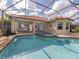 An outdoor living space with a screened-in pool, spa and patio at 190 Montelluna Dr # North, North Venice, FL 34275