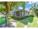 Home exterior featuring a screened-in patio and landscaped backyard at 203 Fontanelle Cir # 203, Venice, FL 34292