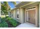 Inviting front entrance with well-maintained landscaping and charming door at 203 Fontanelle Cir # 203, Venice, FL 34292