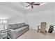 Bright living room featuring a neutral color scheme, fan, and a comfortable sofa at 203 Fontanelle Cir # 203, Venice, FL 34292