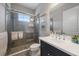 Stylish bathroom featuring a tiled shower with glass doors and a modern vanity at 21248 Holmes Cir, Venice, FL 34293