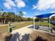 Community dog park offering benches, shade, and play areas for pets at 21248 Holmes Cir, Venice, FL 34293