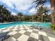 Community pool featuring poolside seating, lounge chairs and shaded pergolas at 21248 Holmes Cir, Venice, FL 34293