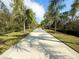 Tree-lined community walkway offering benches and lush greenery along the path at 21248 Holmes Cir, Venice, FL 34293