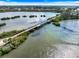 Scenic aerial view of the walking bridge surrounded by a shimmering lake and lush mangroves at 225 Randolph Rd, Venice, FL 34293