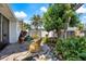 Inviting backyard patio with stone pavers, tropical plants, and comfortable seating area at 225 Randolph Rd, Venice, FL 34293