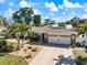 Well-manicured lawn and landscaping highlight this home's exterior and two-car garage at 225 Randolph Rd, Venice, FL 34293