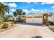 Well-maintained single-story home featuring a two-car garage, stone accents, and well-manicured landscaping at 225 Randolph Rd, Venice, FL 34293