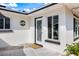 Exterior doorway view on the side of the house with white trim and a well maintained yard at 225 Randolph Rd, Venice, FL 34293