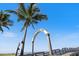 Venice Fishing Pier entrance with palm trees set against a clear blue sky at 225 Randolph Rd, Venice, FL 34293