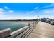 Wooden boardwalk of a pier with blue railings, benches and a small shelter at 225 Randolph Rd, Venice, FL 34293