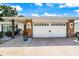 Attached two car garage features stone accents on the home's exterior at 225 Randolph Rd, Venice, FL 34293