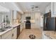 Open kitchen design with white cabinetry, granite counters, stainless appliances, and stylish tile flooring at 225 Randolph Rd, Venice, FL 34293