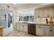 Bright kitchen featuring white cabinets, granite countertops and modern stainless steel appliances at 225 Randolph Rd, Venice, FL 34293