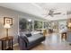 Bright living room featuring neutral color scheme, tile floors and expansive windows overlooking lush backyard with pool at 225 Randolph Rd, Venice, FL 34293