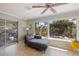 Cozy living room with tile flooring, ceiling fan, sliding glass doors leading to the patio, and a large window at 225 Randolph Rd, Venice, FL 34293