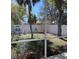 Backyard featuring partial white fence, a house in the distance and tree coverage at 2863 Twinkle Ave, North Port, FL 34286
