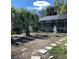 Backyard featuring a screened pool, a stepping stone path and an art sculpture at 2863 Twinkle Ave, North Port, FL 34286