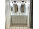 Bright bathroom with a double vanity featuring white cabinets at 2863 Twinkle Ave, North Port, FL 34286