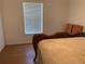 Bedroom with hardwood floors, blinds, and a decorative wooden sleigh bed at 2863 Twinkle Ave, North Port, FL 34286