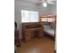 Cozy bedroom featuring bunk beds, a vintage roll top desk, and a bright window at 2863 Twinkle Ave, North Port, FL 34286