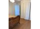 Bedroom with wood floors, closet, and doorway leading to another room at 2863 Twinkle Ave, North Port, FL 34286