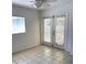 Bright, airy room with tiled floors, a window, and glass paneled doors at 2863 Twinkle Ave, North Port, FL 34286