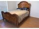 Bedroom showcasing a wooden sleigh bed with decorative headboard and coordinating wood flooring at 2863 Twinkle Ave, North Port, FL 34286