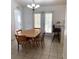 Dining area with tile floors, table and chairs, and counter with barstools at 2863 Twinkle Ave, North Port, FL 34286