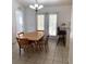 Bright dining room featuring tiled floors, a breakfast bar, and French doors at 2863 Twinkle Ave, North Port, FL 34286