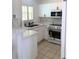 Bright kitchen features white cabinets, sleek appliances, and marble countertops at 2863 Twinkle Ave, North Port, FL 34286