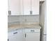 Bright kitchen features sleek white cabinetry, modern black hardware, and a light marble-look countertop at 2863 Twinkle Ave, North Port, FL 34286