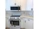 Picture of the kitchen area showcasing white appliances with bronze hardware at 2863 Twinkle Ave, North Port, FL 34286