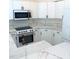 Well-lit kitchen showcasing new, white appliances and matching white cabinetry at 2863 Twinkle Ave, North Port, FL 34286