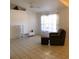 Comfortable living room setup with tile floors, chair with ottoman, and a ceiling fan at 2863 Twinkle Ave, North Port, FL 34286