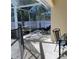 Relaxing screened patio featuring comfortable lounge chair, dining set, and shade creating an inviting outdoor space at 2863 Twinkle Ave, North Port, FL 34286