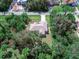 A bird's eye view showing a single-Gathering home surrounded by mature trees in a quiet neighborhood at 3348 Trapper Ln, North Port, FL 34286