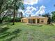 A screened-in lanai and neutral paint complement the spacious backyard with a tree-lined perimeter at 3348 Trapper Ln, North Port, FL 34286