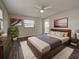 Bedroom with natural light, wood-look floors, and modern furnishings at 345 Three Lakes Ln # L, Venice, FL 34285