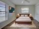 Cozy bedroom with wood-look floors, a ceiling fan, and a decorative rug under the bed at 345 Three Lakes Ln # L, Venice, FL 34285