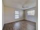 Bedroom with wood floors, ceiling fan, and windows with natural light at 345 Three Lakes Ln # L, Venice, FL 34285