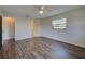 Bright bedroom featuring wood floors, a ceiling fan and a view of the en-suite bathroom with closet at 345 Three Lakes Ln # L, Venice, FL 34285
