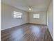 Bright, open bedroom featuring wood-look floors and natural light at 345 Three Lakes Ln # L, Venice, FL 34285