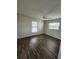 Bedroom with fan, wood flooring, and windows at 345 Three Lakes Ln # L, Venice, FL 34285